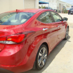 Before and after photographs of a damaged Hyundai Elantra that was repaired by Elite Paint & Body Shop